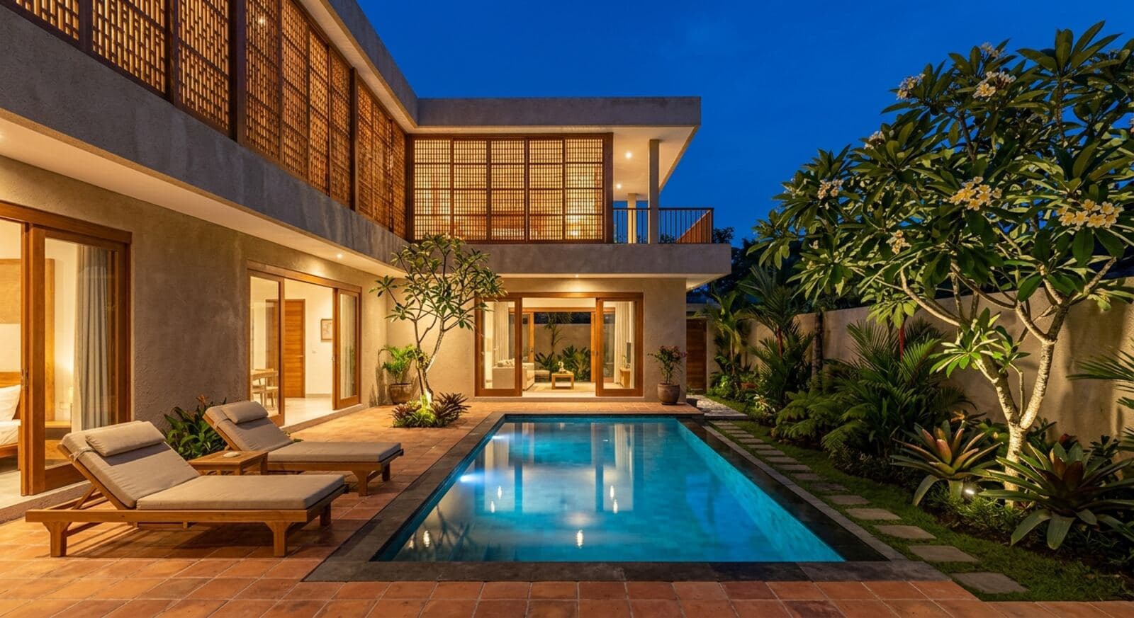 The courtyard at dusk, pool lit